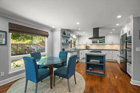a kitchen with a table and chairs in it