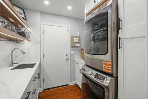 a bathroom with a granite countertop toilet sink and mirror