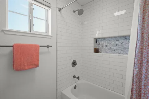 a bedroom with a bed and window