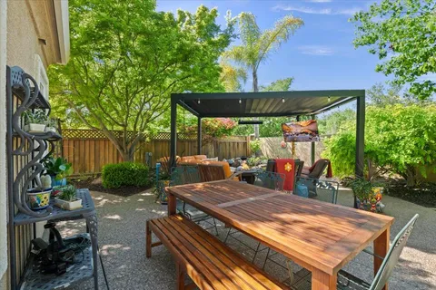 a view of a patio with couches chairs and a couple of flower plants