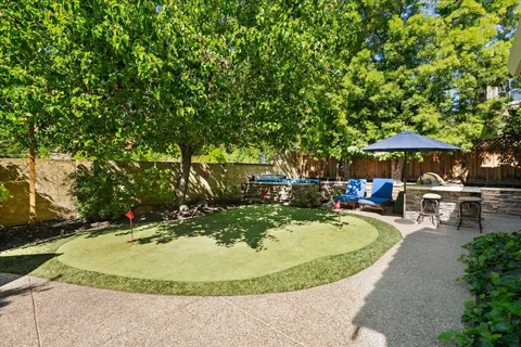 a view of a pathway of a house with wooden fence