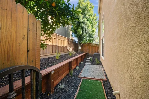 a view of a backyard with chairs and a stove