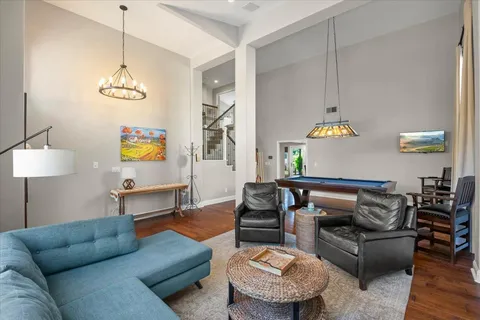 a living room with furniture a rug and a lamp