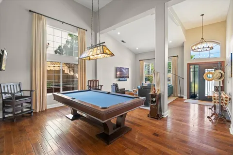 a room with pool table and windows