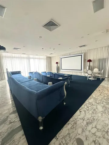 a living room with a couch and a dining table