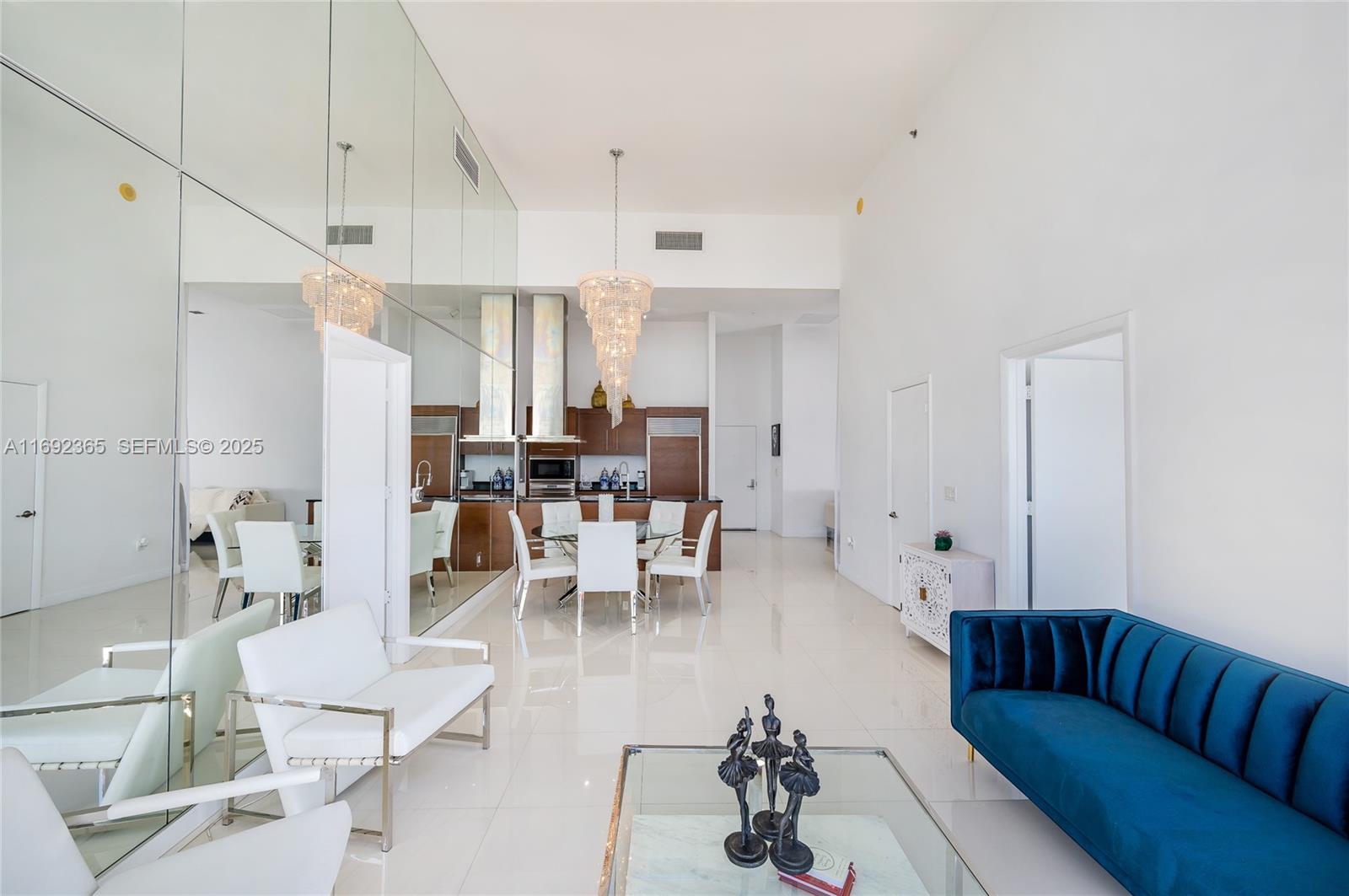 495 Brickell Avenue, Unit 4103 Miami, FL 33131 - Photo 6 of 27 a living room with furniture kitchen view and a chandelier