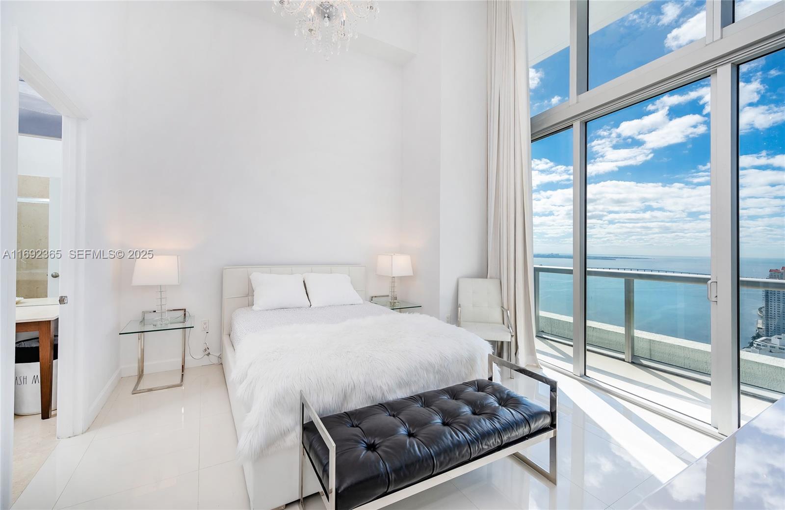 495 Brickell Avenue, Unit 4103 Miami, FL 33131 - Photo 10 of 27 a bedroom with a bed and a large window