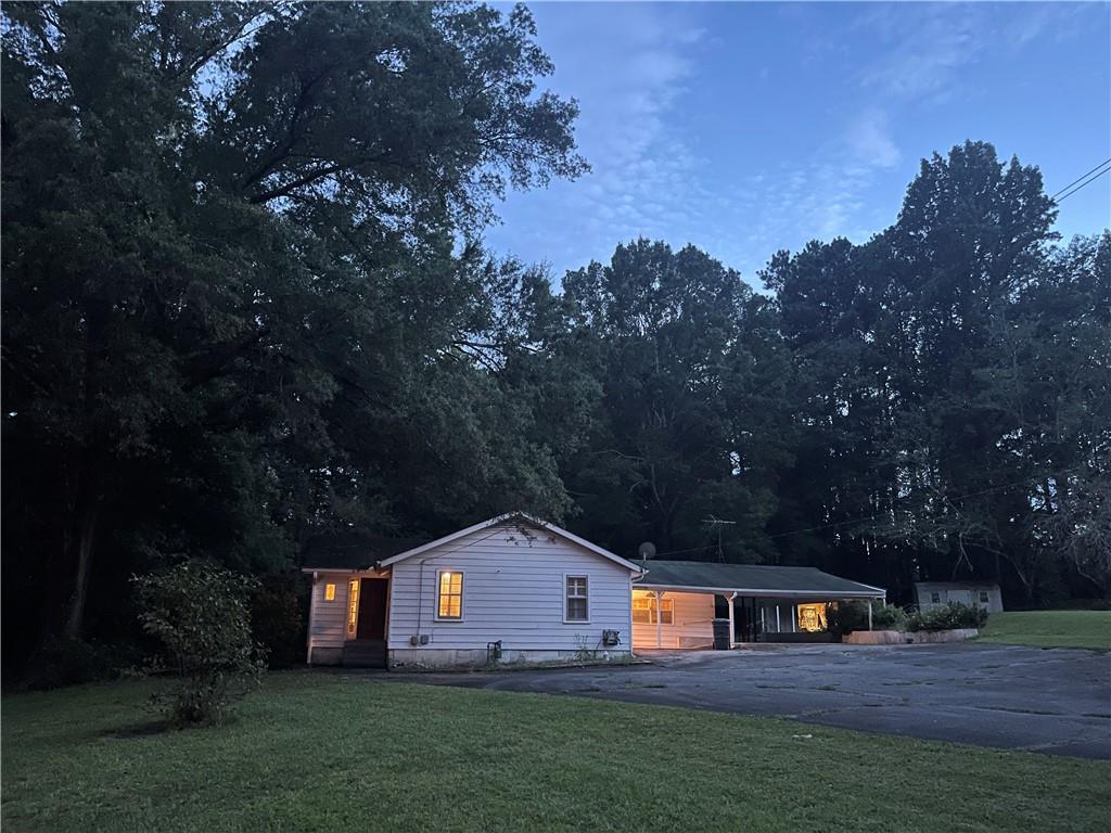 71 McGuire Road Dallas, GA 30157 - Photo 11 of 15 a front view of house with yard and trees in the background
