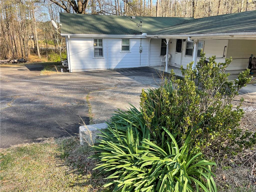 71 McGuire Road Dallas, GA 30157 - Photo 14 of 15 a view of a house with a small yard and plants
