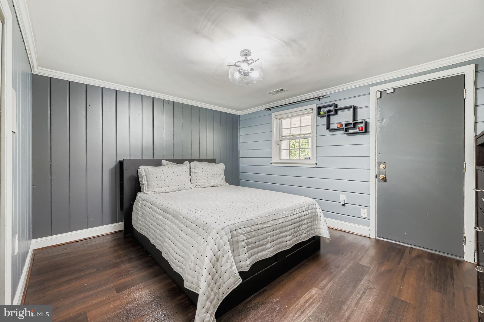 6205 Ridgeview Avenue Baltimore, MD 21206 - Photo 12 of 34 a bedroom with a bed lamp closet and window