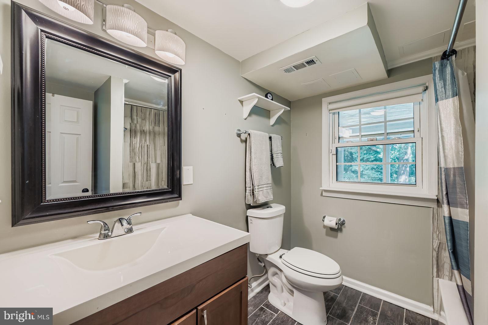 6205 Ridgeview Avenue Baltimore, MD 21206 - Photo 17 of 34 a bathroom with a sink toilet and mirror
