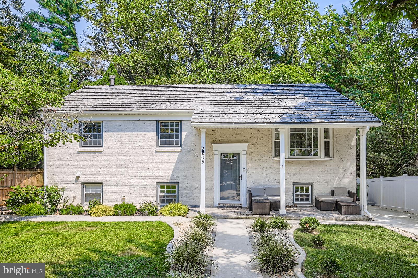 6205 Ridgeview Avenue Baltimore, MD 21206 - Photo 27 of 34 a front view of a house with a garden and yard