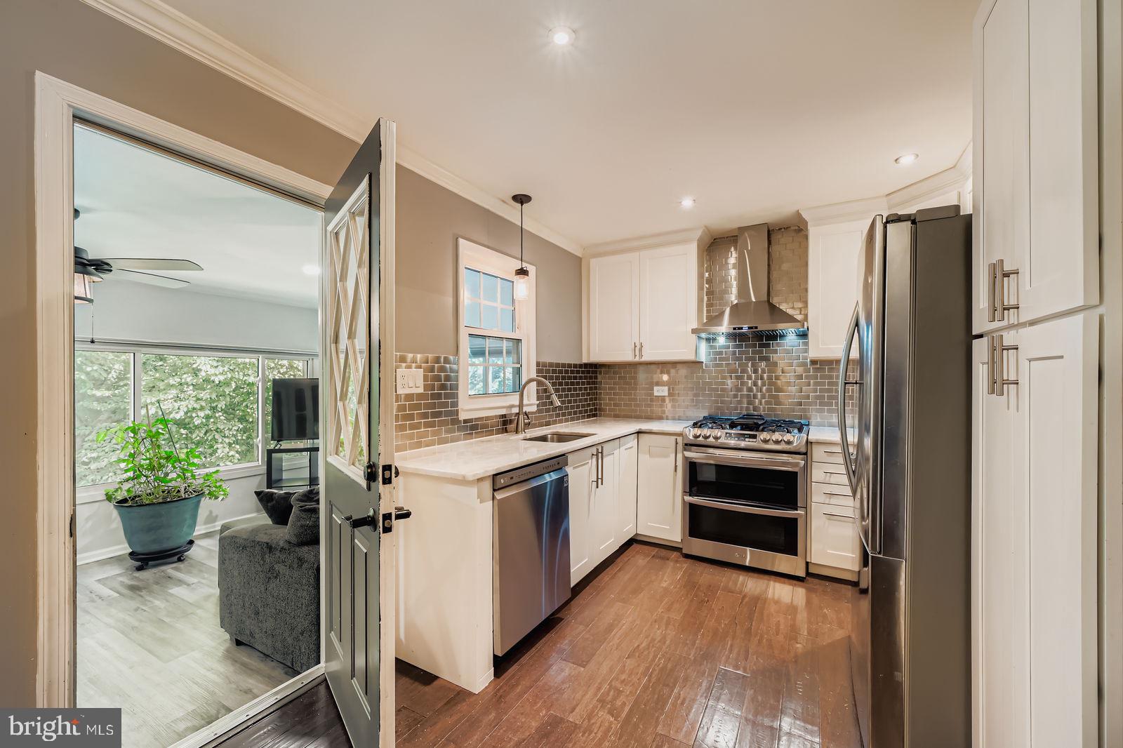 6205 Ridgeview Avenue Baltimore, MD 21206 - Photo 3 of 34 a kitchen with a stove a sink and a refrigerator