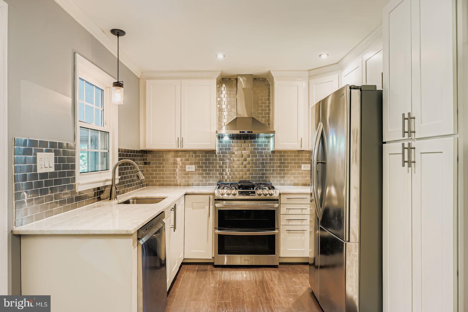 6205 Ridgeview Avenue Baltimore, MD 21206 - Photo 4 of 34 a kitchen with a stove sink and refrigerator