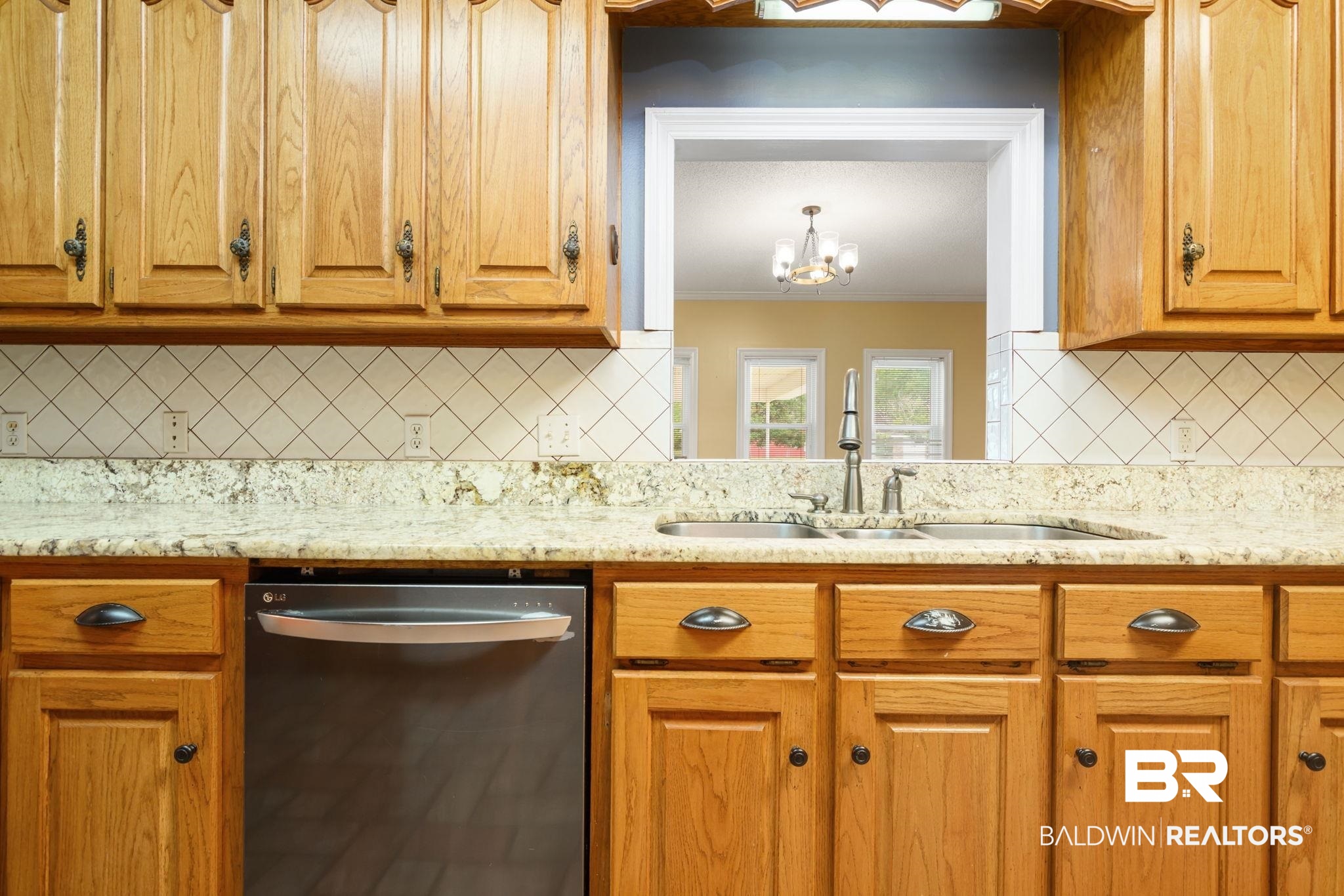 7540 2 Mile Road Irvington, AL 36544 - Photo 21 of 82 Kitchen featuring a double basin stainless steel sink, a stainless steel dishwasher, light wood cabinetry, light stone-look countertops, and a white diagonal tile backsplash