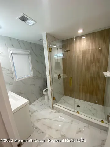 a bathroom with a sink a toilet and a shower