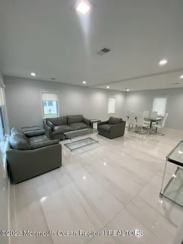 a living room with furniture and a gym