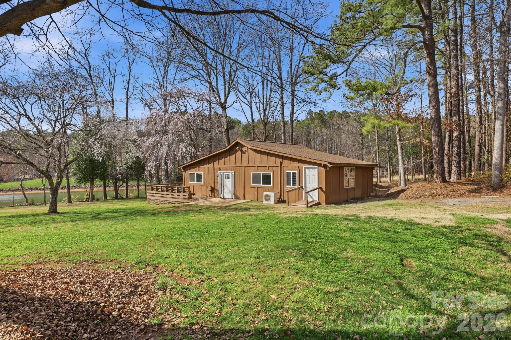232 Apache Road Troutman, NC 28166 - Photo 15 of 25 a house that has a big yard with large trees