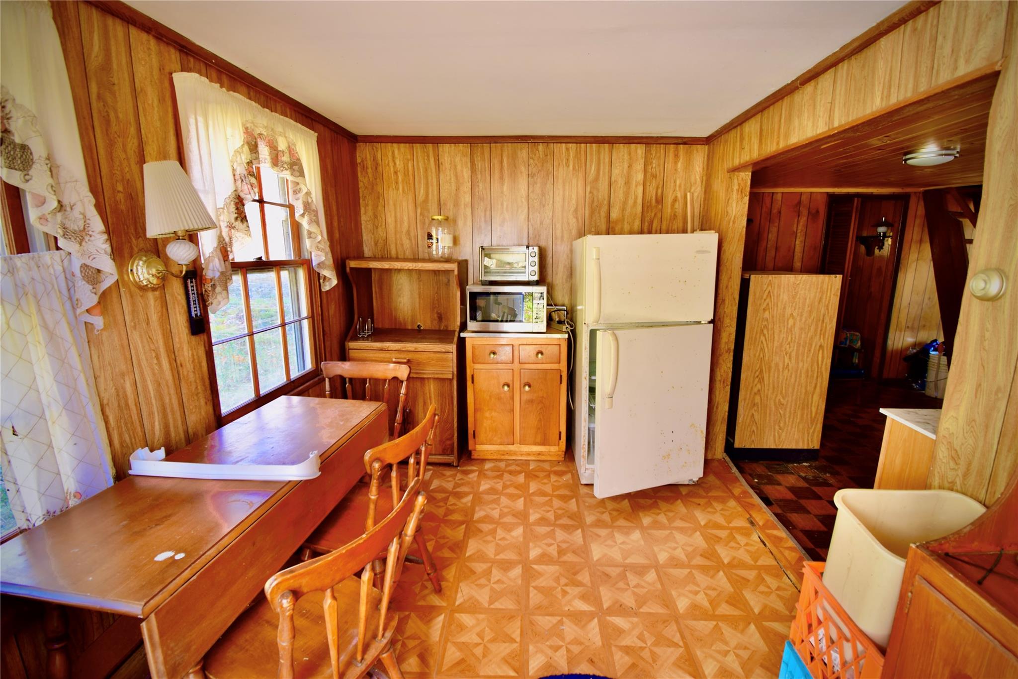 339 Mountain Lake Road Andes, NY 13731 - Photo 26 of 36 Kitchen featuring wood walls, light parquet floors, and white fridge