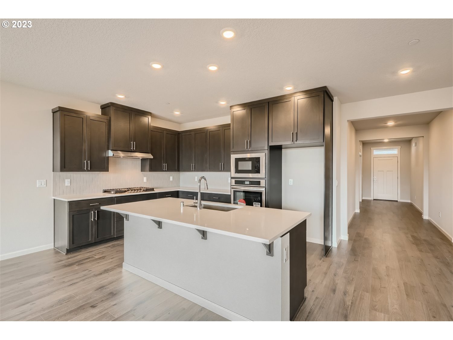 2816 South 7th Circle Ridgefield, WA 98642 - Photo 13 of 25 a kitchen with stainless steel appliances kitchen island a cabinets and wooden floor