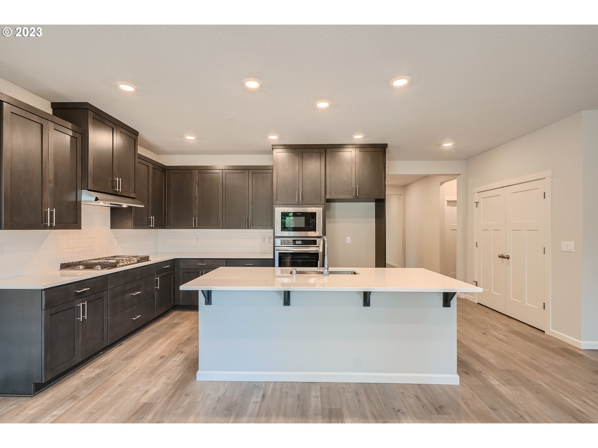 2816 South 7th Circle Ridgefield, WA 98642 - Photo 4 of 25 a large kitchen with stainless steel appliances a large counter top and a refrigerator
