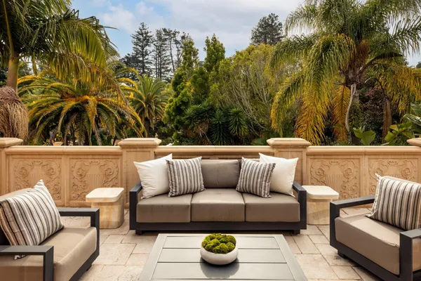 a living room with large couches and a potted plant