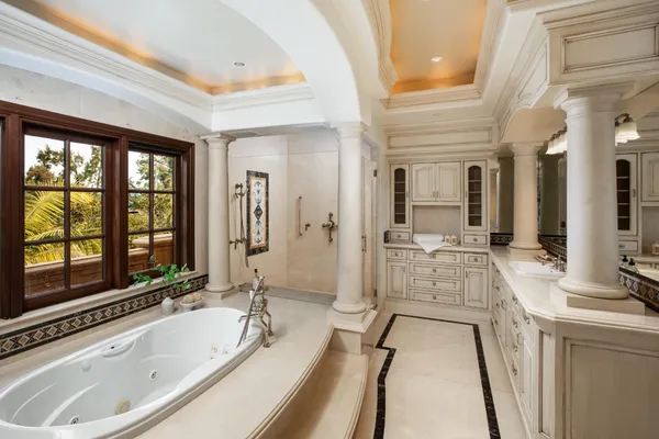 a bathroom with a granite countertop sink a toilet a mirror and shower