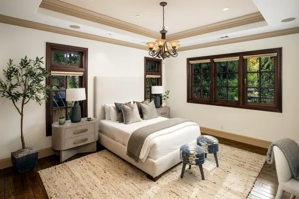 a bedroom with a bed and a chandelier