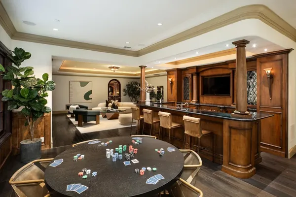 a living room with furniture a rug and chandelier