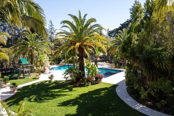 a swimming pool with outdoor seating and yard