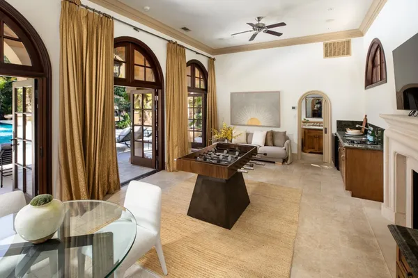 a view of a house with backyard sitting area and swimming pool