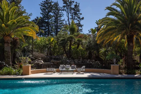 a view of a swimming pool with an outdoor space and seating area