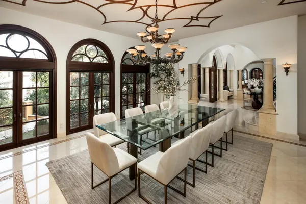 a large white kitchen with a large window and counter top space