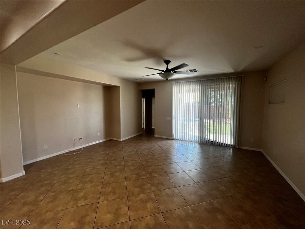 3417 West Birdwatcher Avenue North Las Vegas, NV 89084 - Photo 11 of 28 Tiled empty room featuring baseboards and a ceiling fan