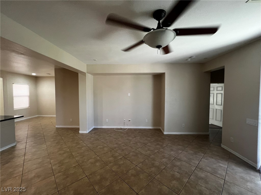 3417 West Birdwatcher Avenue North Las Vegas, NV 89084 - Photo 13 of 28 Empty room with ceiling fan and light tile patterned floors