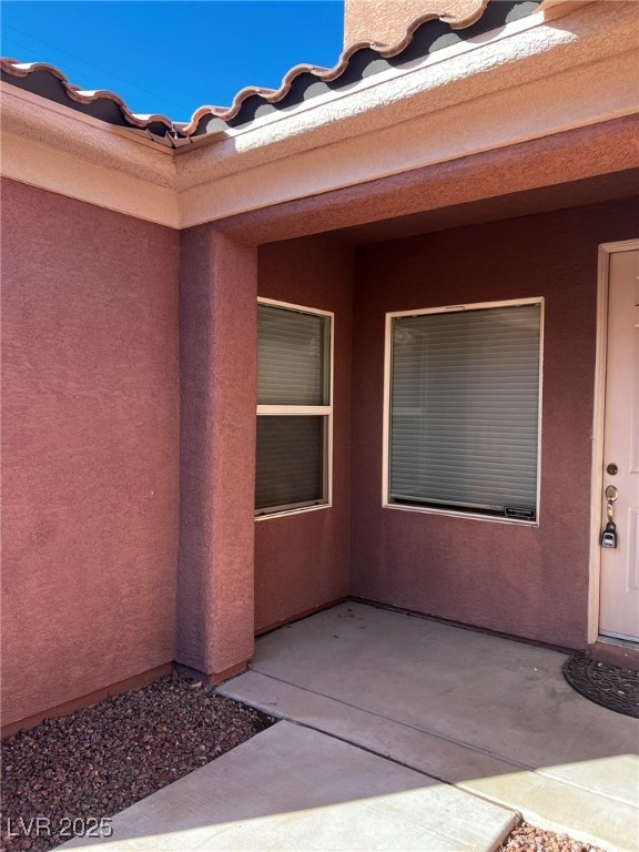 3417 West Birdwatcher Avenue North Las Vegas, NV 89084 - Photo 2 of 28 Doorway to property featuring stucco siding and a patio area