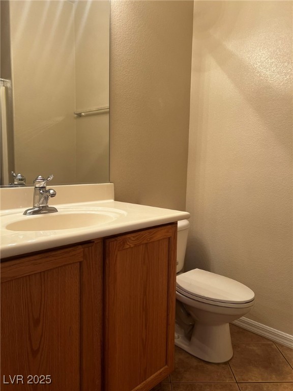 3417 West Birdwatcher Avenue North Las Vegas, NV 89084 - Photo 5 of 28 Half bath with a textured wall, vanity, and dark tile patterned floors