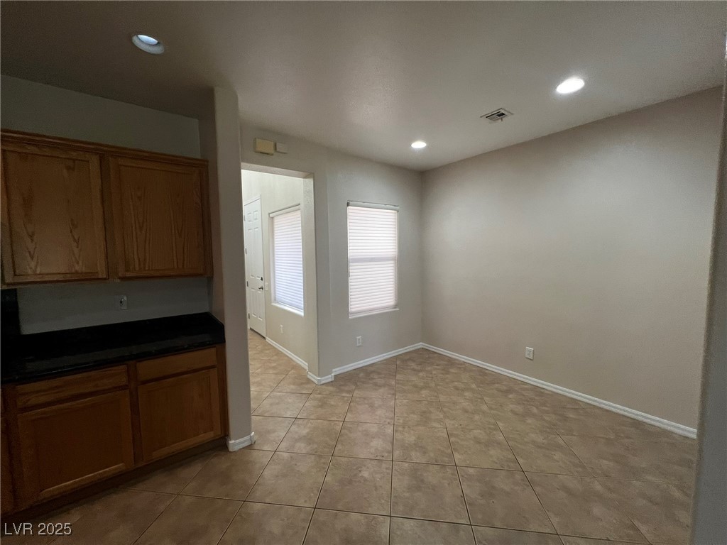 3417 West Birdwatcher Avenue North Las Vegas, NV 89084 - Photo 9 of 28 Kitchen featuring recessed lighting, brown cabinets, and light tile patterned floors