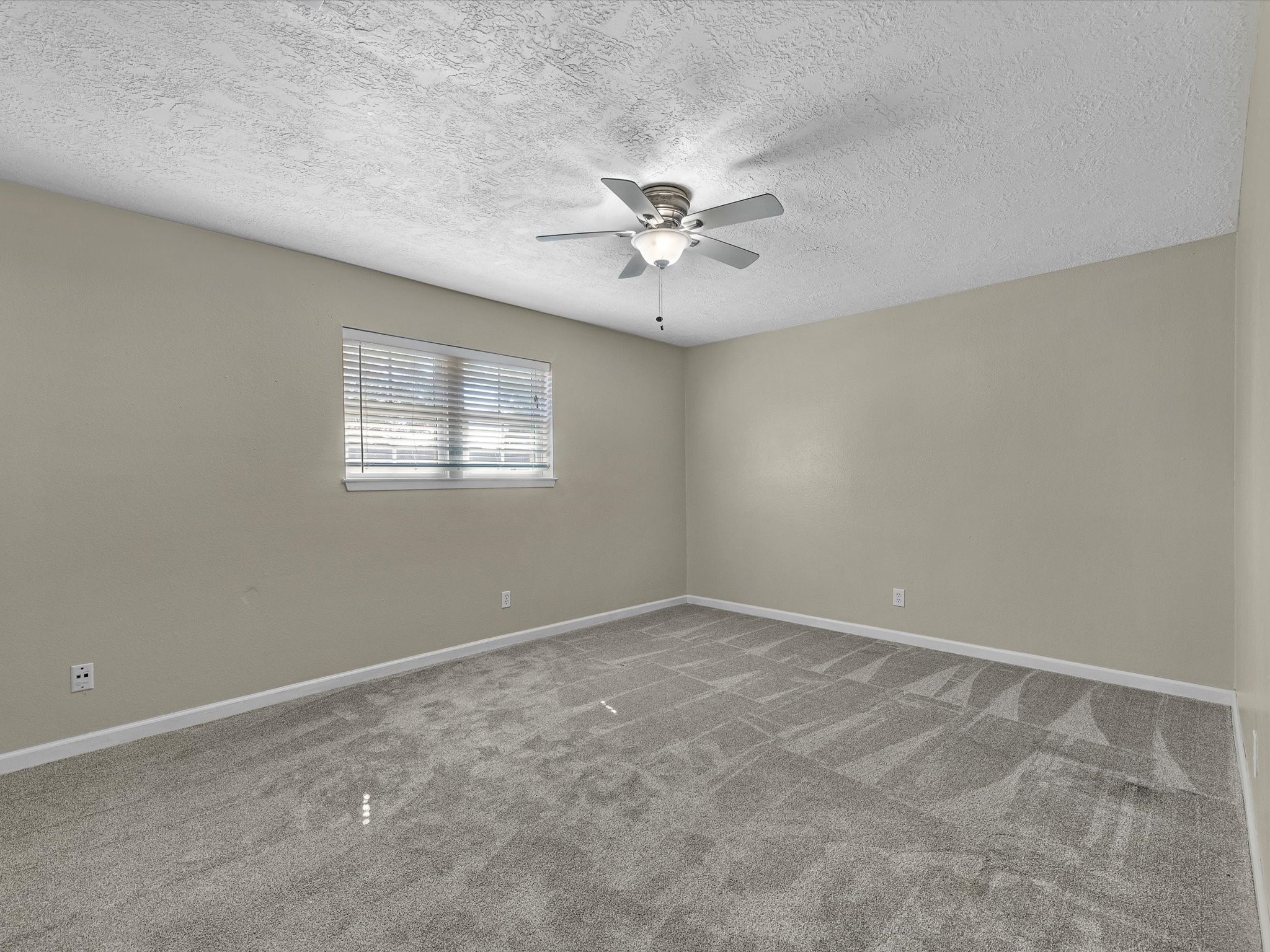 4318 Ponca Street Pasadena, TX 77504 - Photo 15 of 22 an empty room with windows and fan