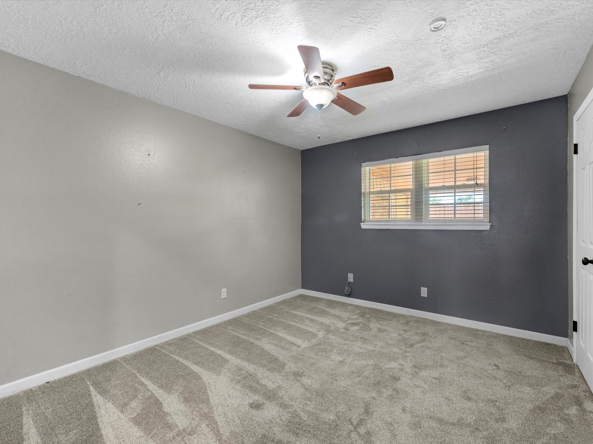4318 Ponca Street Pasadena, TX 77504 - Photo 16 of 22 an empty room with windows and fan