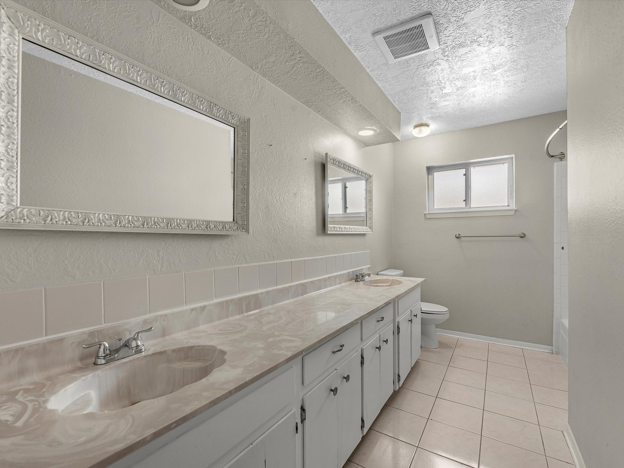 4318 Ponca Street Pasadena, TX 77504 - Photo 17 of 22 a bathroom with a granite countertop sink mirror and double