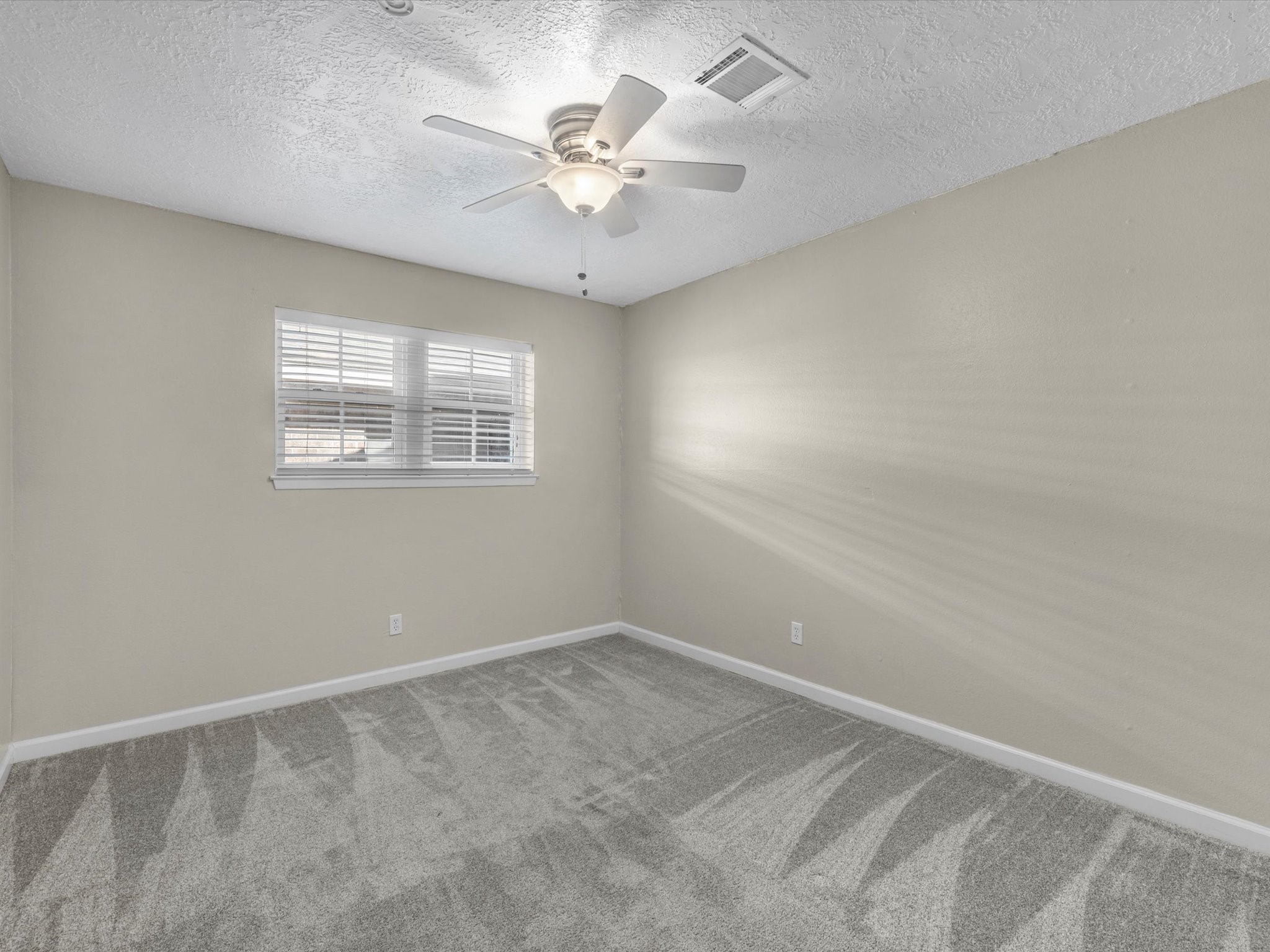 4318 Ponca Street Pasadena, TX 77504 - Photo 18 of 22 an empty room with a chandelier fan and windows