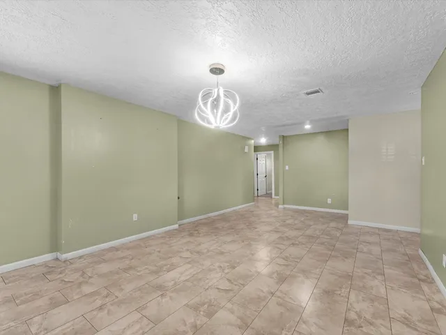 a view of an empty room and a window