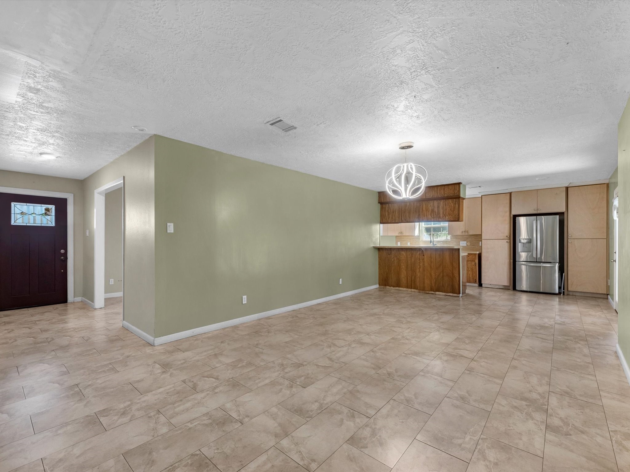 4318 Ponca Street Pasadena, TX 77504 - Photo 5 of 22 a view of an empty room with window and cabinet