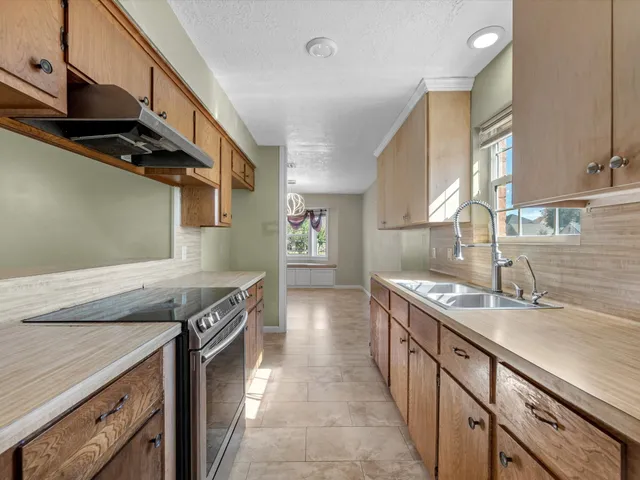 a kitchen with stainless steel appliances granite countertop a sink and a stove