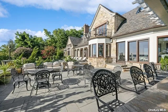 a view of a patio with couches table and chairs and potted plants