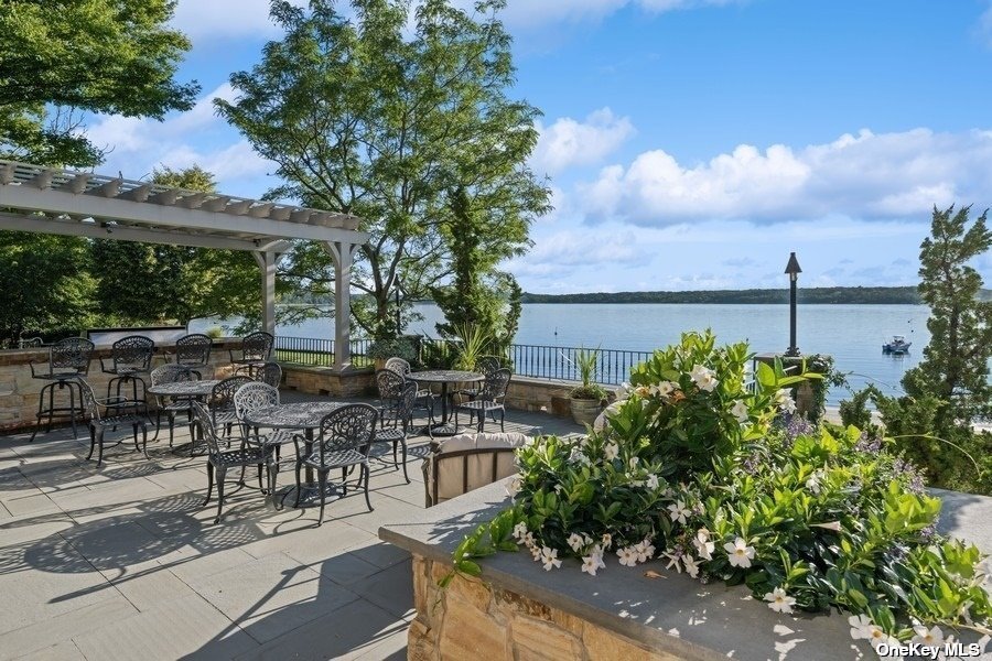 200 Centre Island Road Centre Island, NY 11771 - Photo 23 of 31 a view of a patio with table and chairs potted plants with lake view