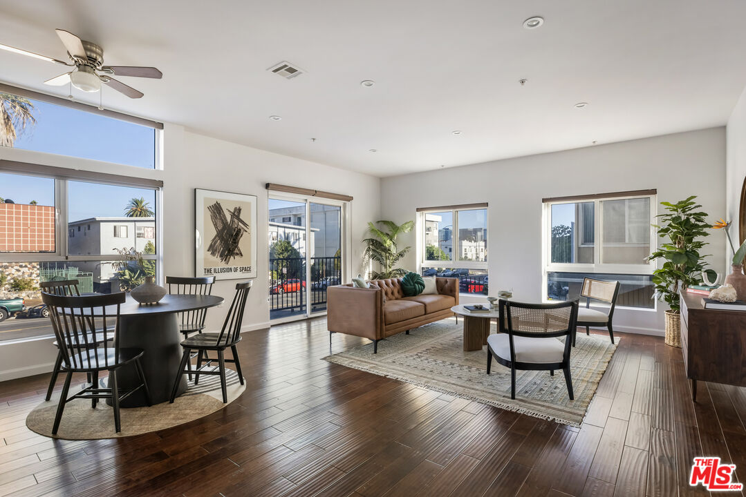 a view of a dining room with furniture window and wooden floor