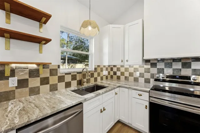 a kitchen with a sink stove and cabinets