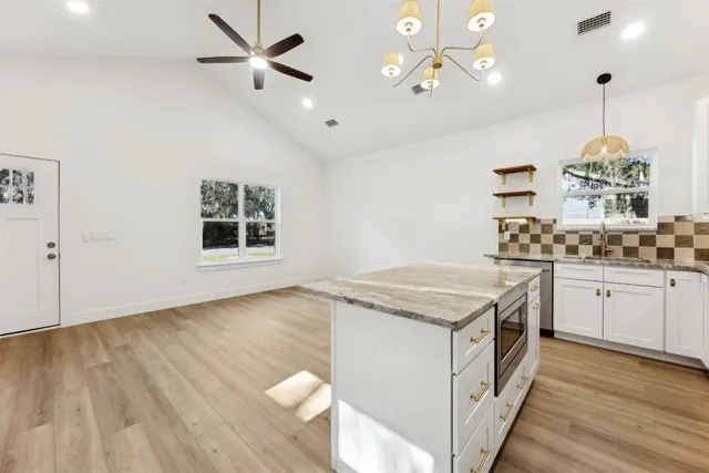 a kitchen that has a lot of cabinets in it